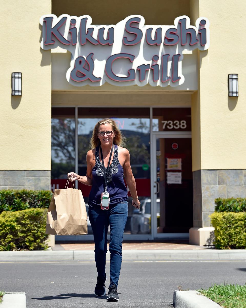 Betsy Bray has been a gig worker for five years. These days she mainly does Instacart but also picks up for DoorDash, UberEats and GrubHub in and around northwest Bradenton. Here Bray, picks up a lunch delivery from Kiku Sushi & Grill located in Bradenton.