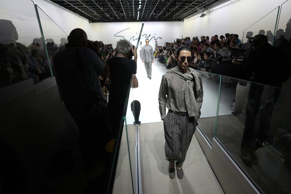 A model wears a creation as part of the Giorgio Armani men's Spring Summer 2024 collection presented in Milan, Italy, Monday, June 19, 2023. (AP Photo/Luca Bruno)