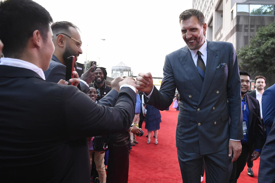 Dirk Nowitzki greets fans as he arrives on the red carpet for his enshrinement at the Basketball Hall of Fame on Saturday, Aug. 12, 2023, in Springfield, Mass. (AP Photo/Jessica Hill)