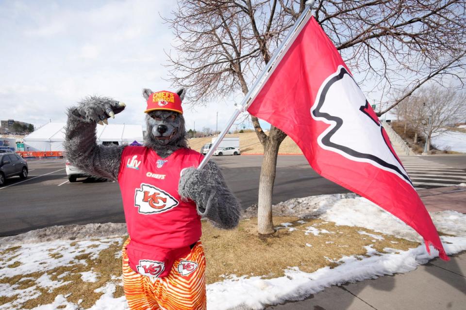 ChiefsAholic, also known as Xaviar Babudar, poses for photos while walking toward Empower Field at Mile High before a Denver Broncos and Kansas City Chiefs game on January 8, 2022 (AP)