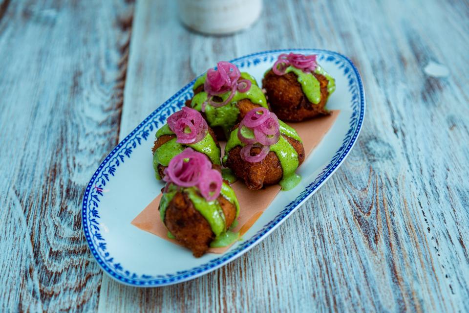 At Sassafras. hush puppies with green goddess dressing and pickled pearl onions. The Southern restaurant is located in downtown West Palm Beach.   