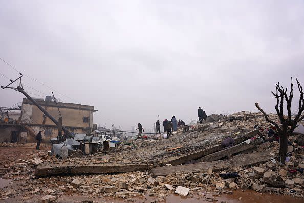 Residents sift through the rubble of a collapsed building, looking for victims and survivors, following an earthquake in the town of Jandaris, in the countryside of Syria's northwestern city of Afrin in the rebel-held part of Aleppo province, on February 6, 2023. - Hundreds have been reportedly killed in north Syria after a 7.8-magnitude earthquake that originated in Turkey and was felt across neighbouring countries. (Photo by Rami al SAYED / AFP) (Photo by RAMI AL SAYED/AFP via Getty Images)