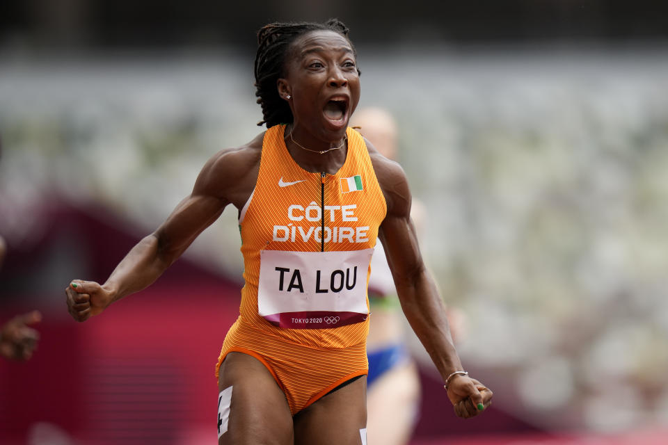 Marie-Josee Ta Lou, of the Ivory Coast, wins a heat in the women's 100-meter run at the 2020 Summer Olympics, Friday, July 30, 2021, in Tokyo. (AP Photo/Petr David Josek)