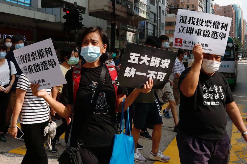 Pro-democracy protesters march during a demonstration oppose postponed elections, in Hong Kong