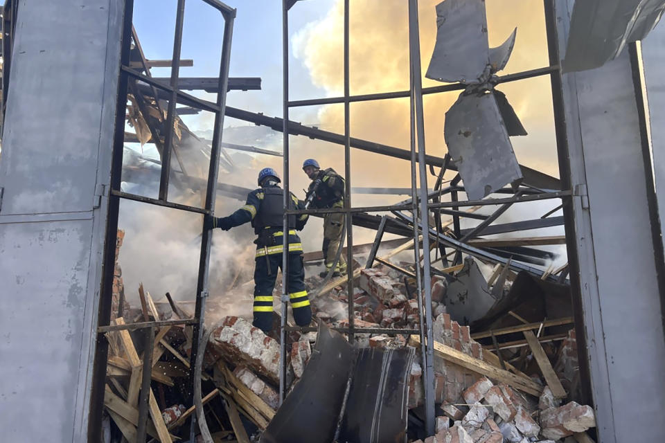 In this photo provided by the Ukrainian Emergency Service, emergency services personnel work to extinguish a fire following a Russian attack in Kryvyi Rih, Ukraine, Friday, Sept. 8, 2023. (Ukrainian Emergency Service via AP)