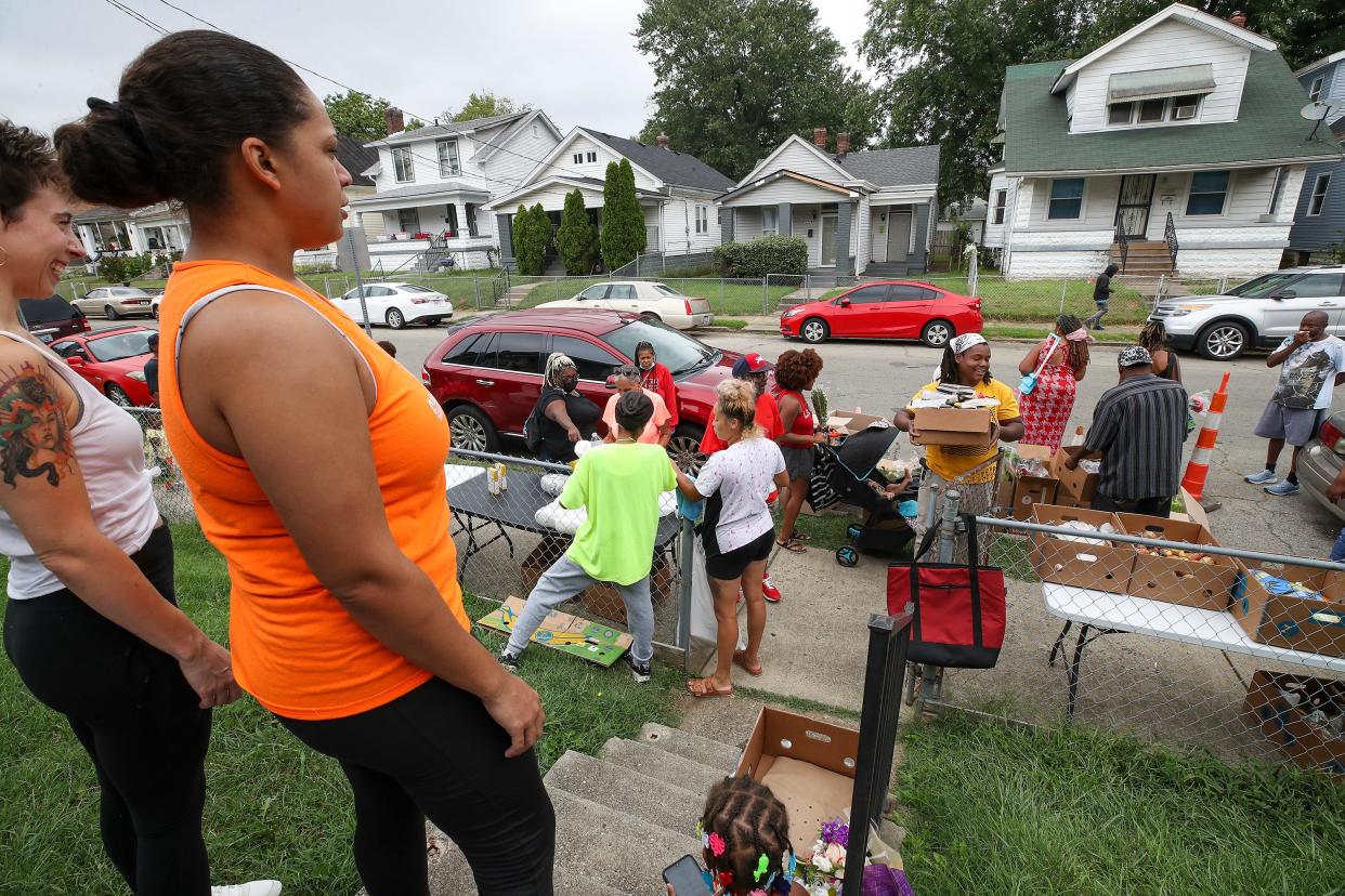 Taylor Ryan, with Change Today, Change Tomorrow, watches food distribution in front of her home on Date Street on Thursday, September 7, 2023
