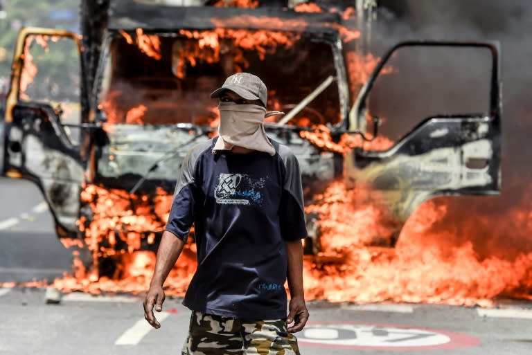 A truck set ablaze by opposition activists burns in Caracas