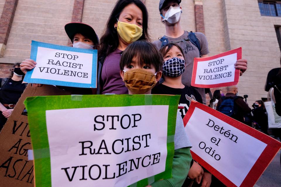 A family takes part in a rally to raise awareness of anti-Asian violence, at the Japanese American National Museum in Little Tokyo in Los Angeles on March 13, 2021.