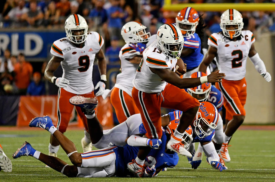 Miami Hurricanes running back DeeJay Dallas (13) breaks a tackle against the Florida Gators during the second half at Camping World Stadium. (USAT)