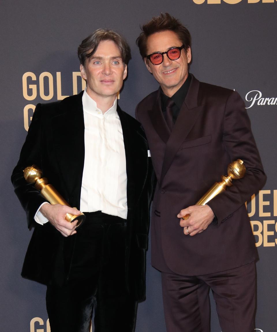 "Oppenheimer" co-stars Cillian Murphy (left) and Robert Downey Jr. pose with their Golden Globe trophies. The movie also won best drama.