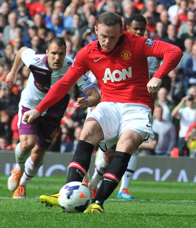 Manchester United's Wayne Rooney scores his team's second goal from a penalty during their English Premier League match against Aston Villa, at Old Trafford in Manchester, northwest England, on March 29, 2014