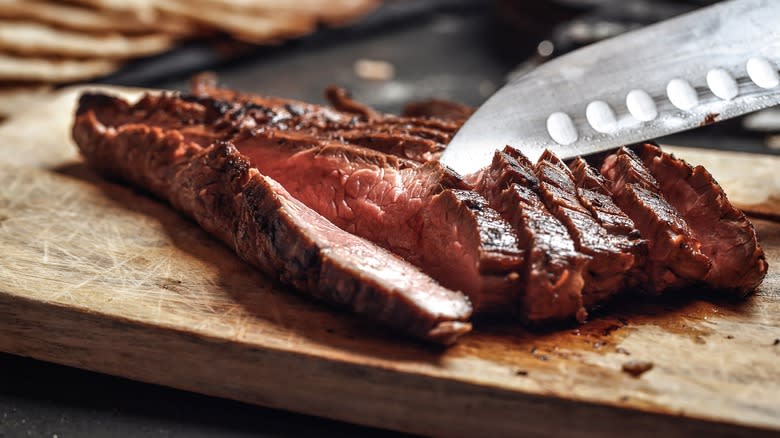 flank steak sliced on board