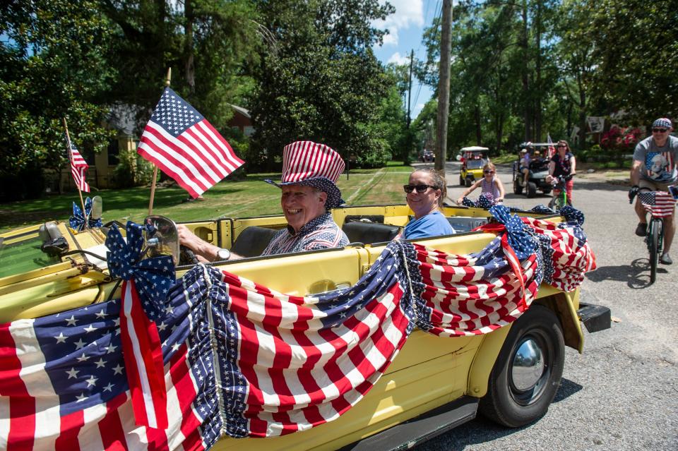 Charlie Colvin leads the way as neighbors parade through the streets for the annual Cloverdale-Idlewild Fourth of July parade in Montgomery.