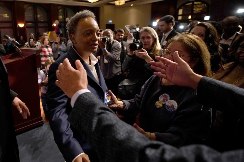 Chicago Mayor Lori Lightfoot, left, walks into the open arms of a supporter after conceding the mayoral election late Tuesday.