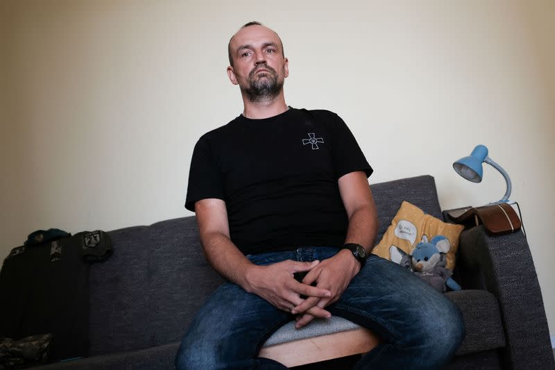 Ukrainian soldier Dovzhenko, 41 looks on during an interview for Reuters at his home in Wroclaw