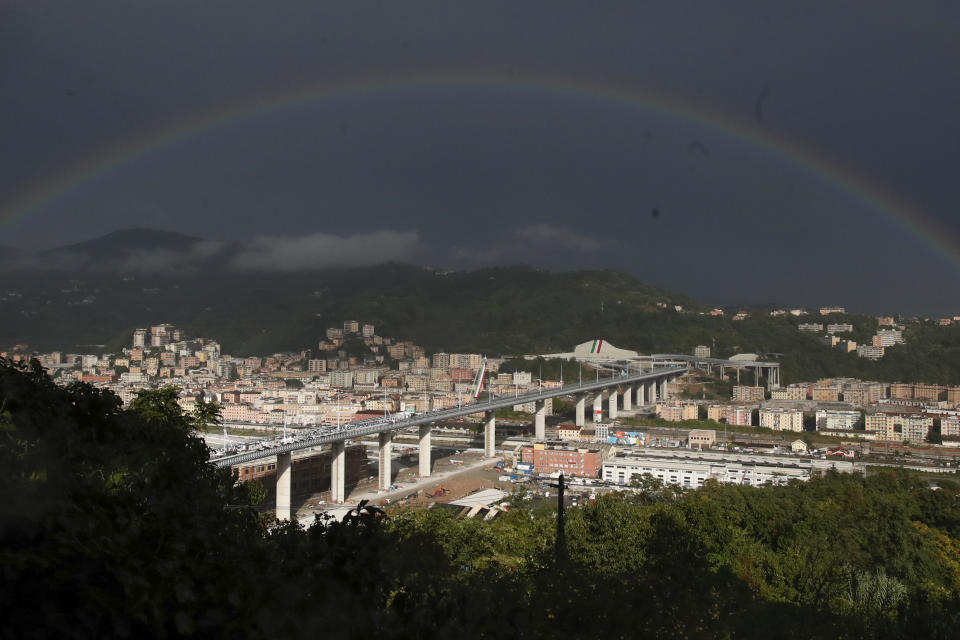 A rainbow shines over the new San Giorgio Bridge in Genoa, Italy, Monday, Aug. 3, 2020. Two years ago this month, a stretch of roadbed collapsed on Genoa's Morandi Bridge, sending cars and trucks plunging to dry riverbed below and ending 43 lives. On Monday, Italy's president journeys to Genoa for a ceremony to inaugurate a replacement bridge. (AP Photo/Antonio Calanni)