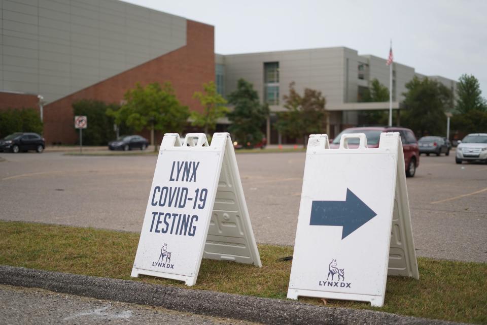 Signs for COVID-19 testing are set in the parking lot of Detroit Renaissance High School in Detroit on September 20, 2021.