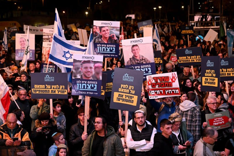 Right-wing Israelis hold placards and photos of soldiers killed in Gaza at a protest outside the office of Prime Minister Benjamin Netanyahu in Jerusalem, calling for the war against Hamas to continue until a decisive victory, on Thursday. Photo by Debbie Hill/UPI