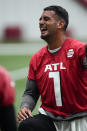 Atlanta Falcons quarterback Marcus Mariota laughs as he stretches during NFL football practice Thursday, May 26, 2022, in Flowery Branch, Ga. (AP Photo/John Bazemore)