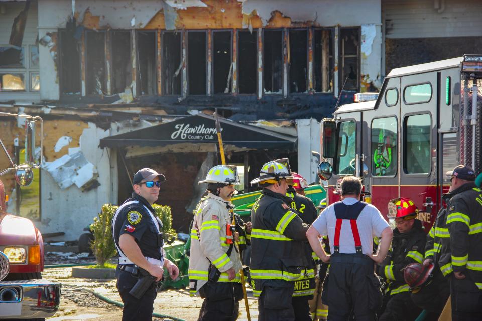 In this file photo, fire crews take a breather after fighting a devastating fire at the Hawthorne Country Club on Tucker Road in Dartmouth on Sunday, May 7.