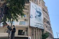 A poster of founder of Lebanese Forces and Lebanese assassinated president-elect Bashir Gemayel, is seen flanked on a building in Beirut