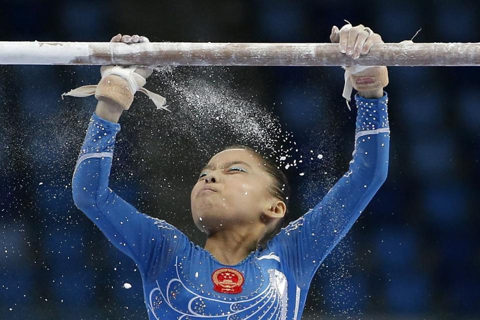 China's Shang Chunsong prepares to compete in the uneven bars event of the women's individual all-around final artistic gymnastics competition at the Namdong Gymnasium Club during the 17th Asian Games in Incheon, in this September 23, 2014 file photo. REUTERS/Kim Hong-Ji/Files (SOUTH KOREA - Tags: SPORT GYMNASTICS TPX IMAGES OF THE DAY)