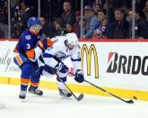 May 6, 2016; Brooklyn, NY, USA; Tampa Bay Lightning center Alex Killorn (17) plays the puck against New York Islanders defenseman Travis Hamonic (3) during the third period of game four of the second round of the 2016 Stanley Cup Playoffs at Barclays Center. Mandatory Credit: Brad Penner-USA TODAY Sports