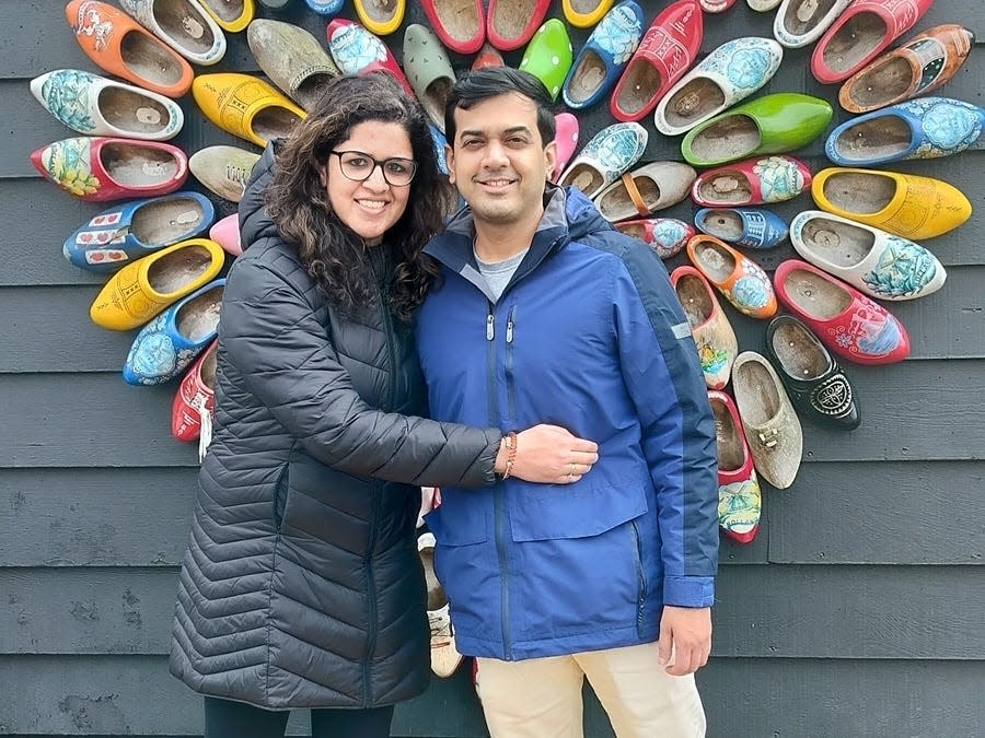 Man and woman standing together in giant yellow shoes