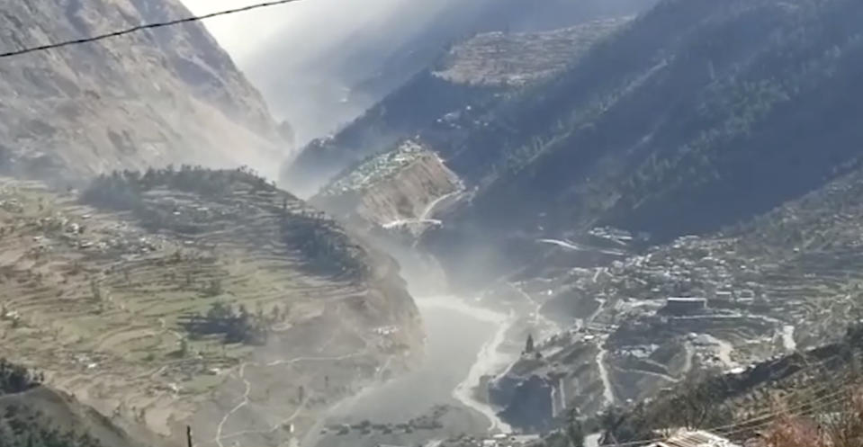 This frame grab from video provided by KK Productions shows a massive flood of water, mud and debris flowing at Chamoli District after a portion of Nanda Devi glacier broke off in Tapovan area of the northern state of Uttarakhand, India, Sunday, Feb.7, 2021. (KK Productions via AP)