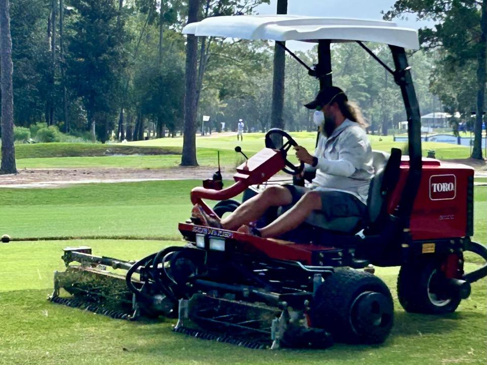 A Timuquana Country Club agronomy staff member mows the grass near the 18th tee on Sept. 29 in preparation for the Constellation Furyk & Friends Oct. 6-8.