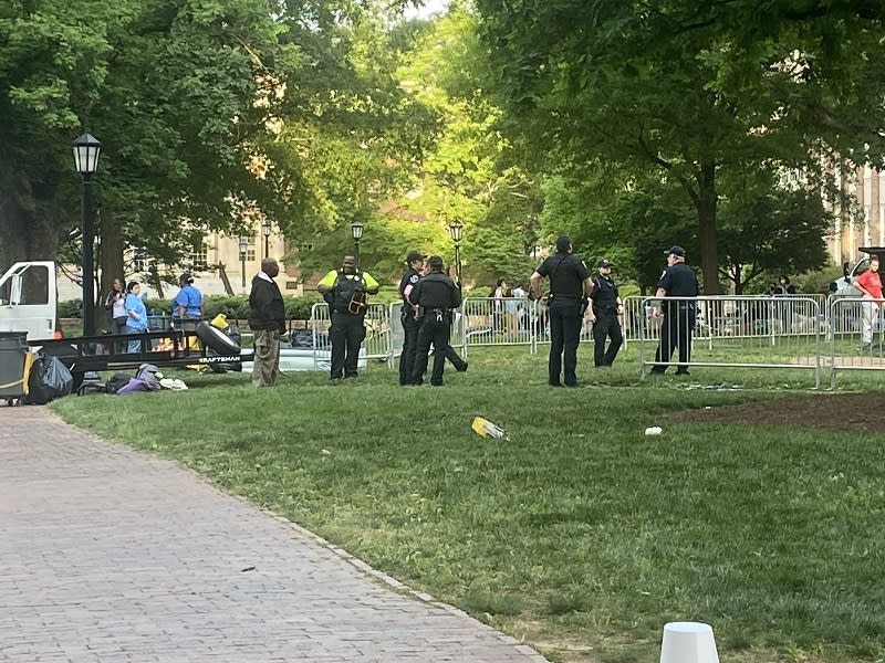 Police and crews cleaning up the encampment area Tuesday morning. (Joseph Holloway / CBS 17)