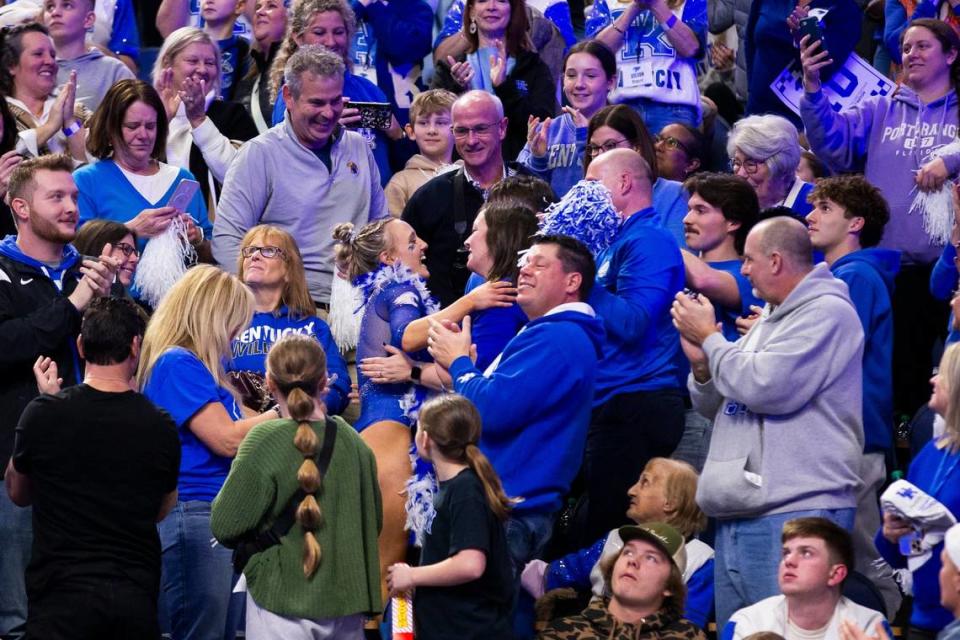 Raena Worley celebrates with her family in the stands after her floor routine during Kentucky’s annual Excite Night meet against Georgia at Rupp Arena this season. Arden Barnes/Lexington