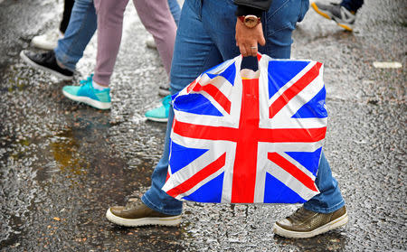 A pedestrian carries a British union flag design plastic bag in Leicester Square in London, Britain, March 29, 2018. REUTERS/Toby Melville