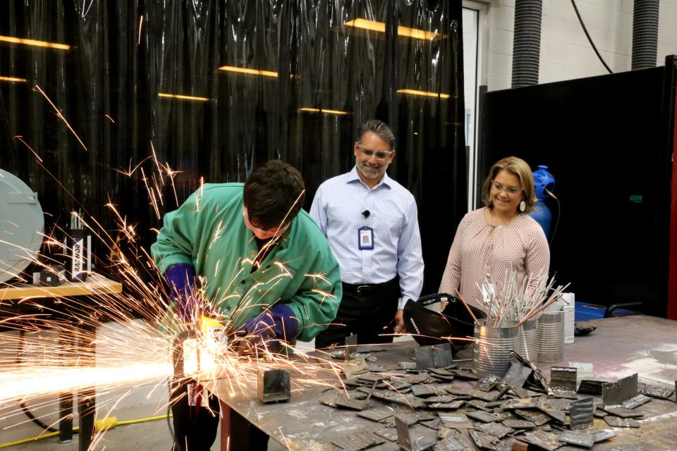 Stephen Proia, plant manager for Texas Instruments in Sherman, and Principal Jenifer Politi spent time with CTE students as they completed metalworking, woodworking and other projects during class.