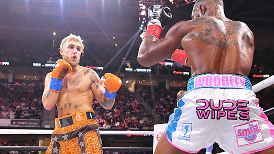 Jake Paul (pictured left) getting ready to throw a punch at Tyrone Woodley (pictured right).