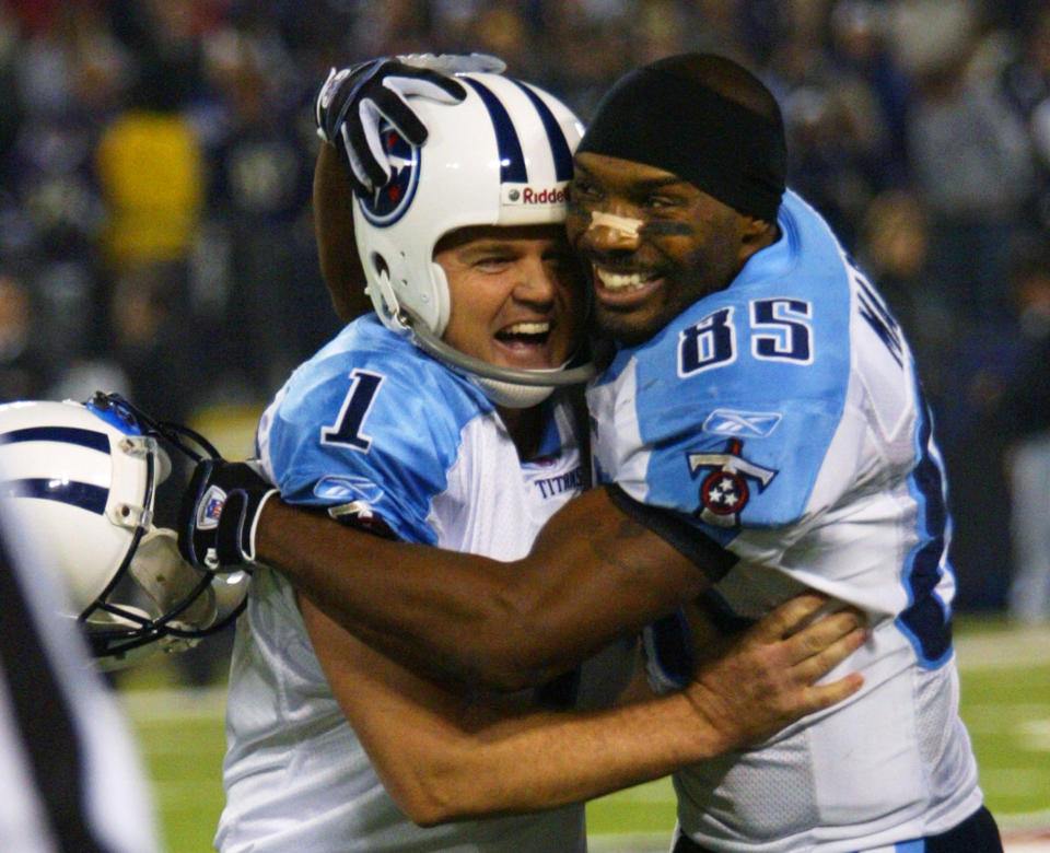 FILE - In this Jan. 3, 2004, file photo, Tennessee Titans' receiver Derrick Mason, right, hugs kicker Gary Anderson after his game-winning fourth quarter touchdown against the Baltimore Ravens during their AFC wildcard playoff game in Baltimore. The Titans playing the Ravens in the divisional round Saturday, Jan. 11, 2020, has revived strong memories of a very intense and bitter playoff rivalry along with the agony of possible Super Bowl titles lost. (AP Photo/Rusty Kennedy, File)