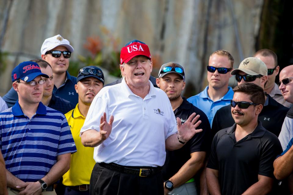 President Donald Trump welcomes members of the U.S. Coast Guard to a tournament and lunch at the Trump International Golf Club in Palm Beach on Thursday, December 29, 2017.