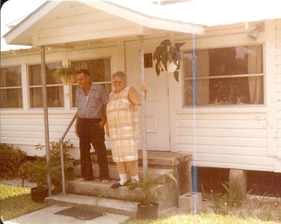 Della Alvarez and Hugh Smith stand in front of the old home on Highlands Avenue in Estero.