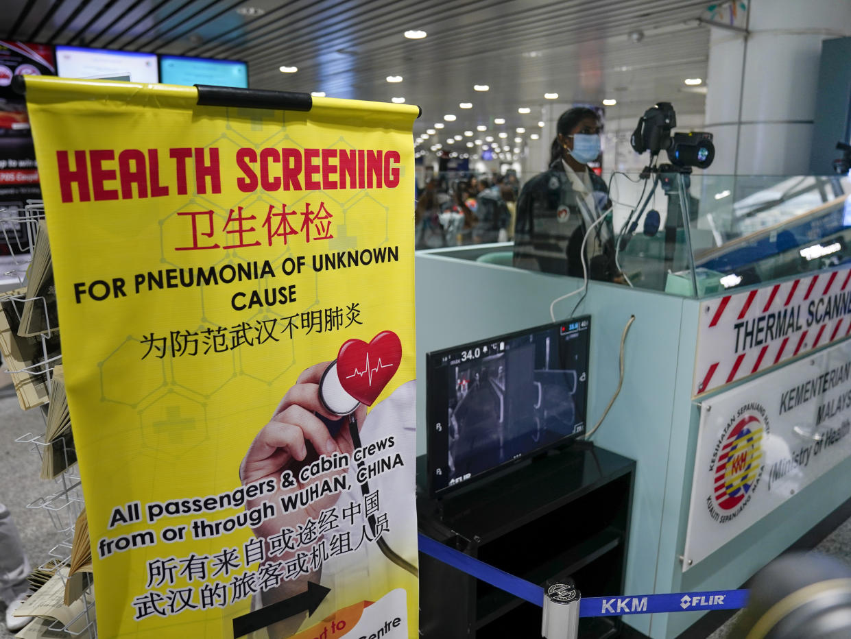 Health officials watch thermographic monitors at a quarantine inspection station at the Kuala Lumpur International Airport in Sepang, Malaysia, Tuesday, Jan. 21, 2020.Countries both in the Asia-Pacific and elsewhere have initiated body temperature checks at airports, railway stations and along highways in hopes of catching those at risk of carrying a new coronavirus that has sickened more than 200 people in China. (AP Photo/Vincent Thian)