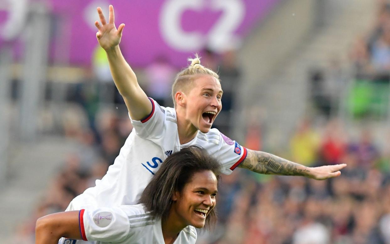 Lyon's Welsh midfielder Jess Fishlock (L) and Lyon's French defender Wendie Renard celebrate after the UEFA Women's Champions League fi - Tobias SCHWARZ / AFP