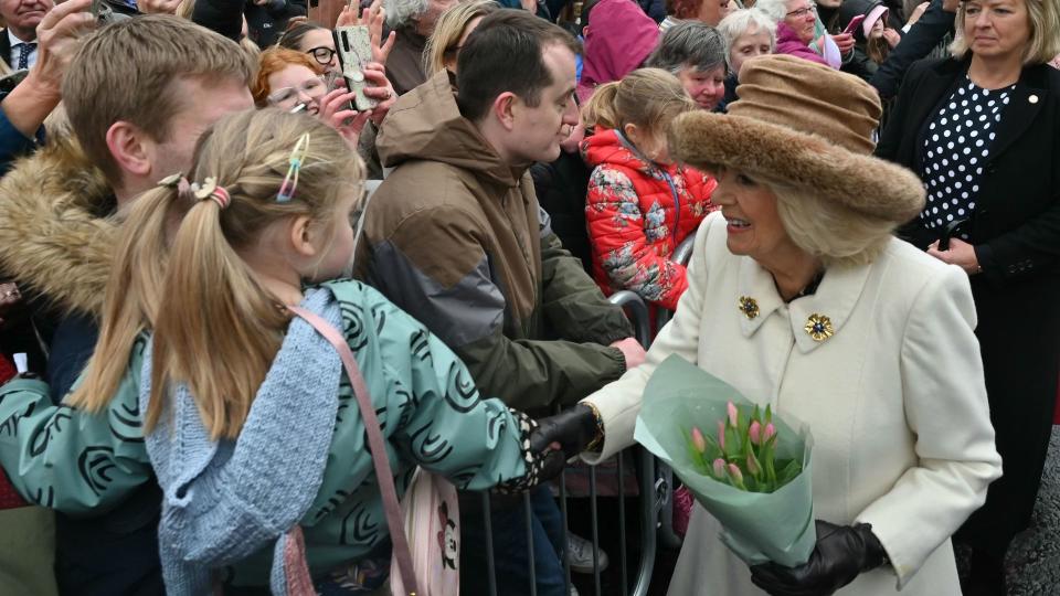 Queen Camilla greets the crowd outside Worcester Cathedral