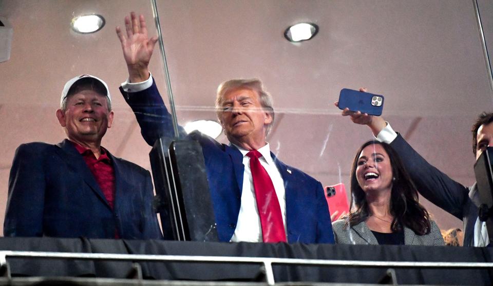 September 28, 2024; Tuscaloosa, Alabama, USA; Former President and current Republican presidential candidate Donald J. Trump visits Bryant-Denny Stadium for the Alabama-Georgia football game. Trump stands next to Senator Katie Britt, Republican of Alabama, and waves to the crowd. Mandatory attribution: Gary Cosby Jr.-Imagn Images