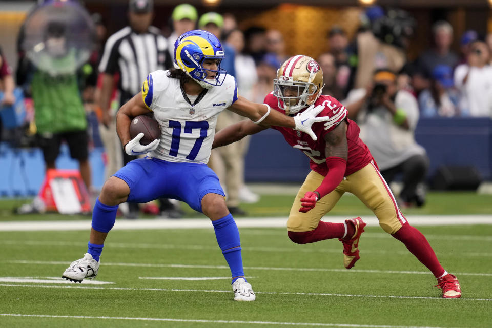 Los Angeles Rams wide receiver Puka Nacua, left, tries to fend off San Francisco 49ers cornerback Deommodore Lenoir during the second half of an NFL football game Sunday, Sept. 17, 2023, in Inglewood, Calif. (AP Photo/Ashley Landis)