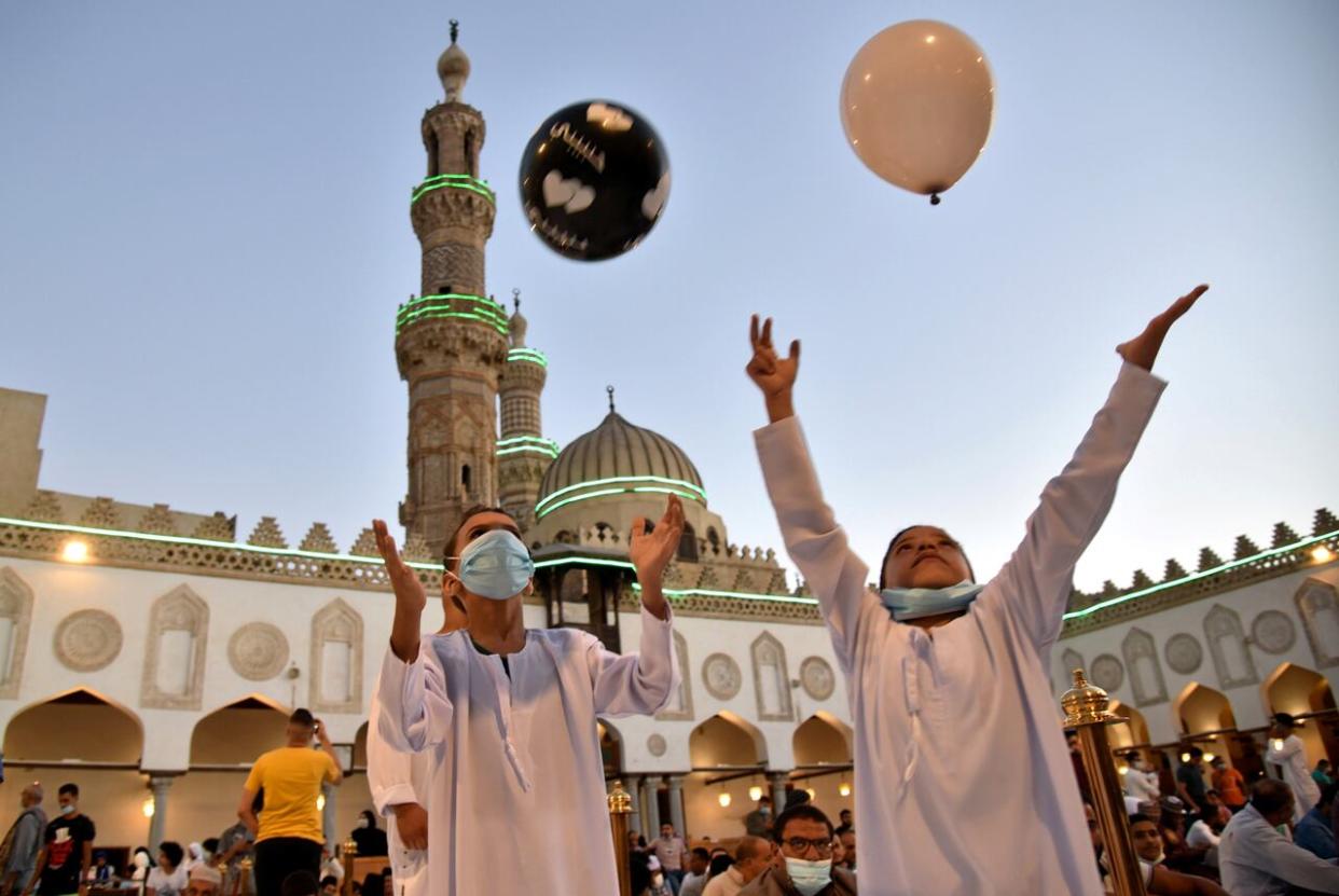 Kids play with balloons after Eid prayer inside Al-Azhar Mosque in Cairo, Egypt. (Mohamed Abd El Ghany/Reuters - image credit)