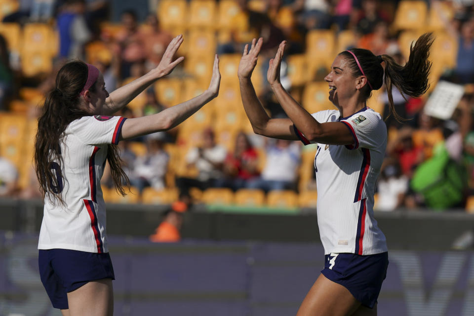 United States' Alex Morgan, right, celebrates with teammate Rose Lavelle scoring her side's second goal against Haiti during a CONCACAF Women's Championship soccer match in Monterrey, Mexico, Monday, July 4, 2022. (AP Photo/Fernando Llano)