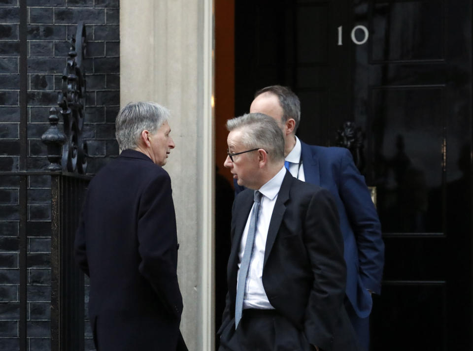 Chancellor of the Exchequer Philip Hammond, left, arrives at 10 Downing street as Environment Secretary Michael Gove leaves the Prime Minister's residence in London, Thursday Jan. 17, 2019. Britain's Prime Minister Theresa May is reaching out to opposition parties and other lawmakers Thursday in an effort to put Brexit back on track, after surviving a no-confidence vote Wednesday. (AP Photo/Frank Augstein)