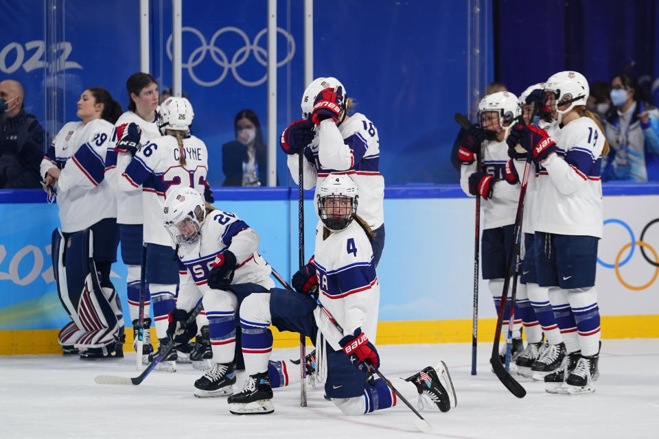 The United States team watches as Canada players celebrate after winning the women's gold medal hockey game at the 2022 Winter Olympics, Thursday, Feb. 17, 2022, in Beijing. (AP Photo/Matt Slocum)