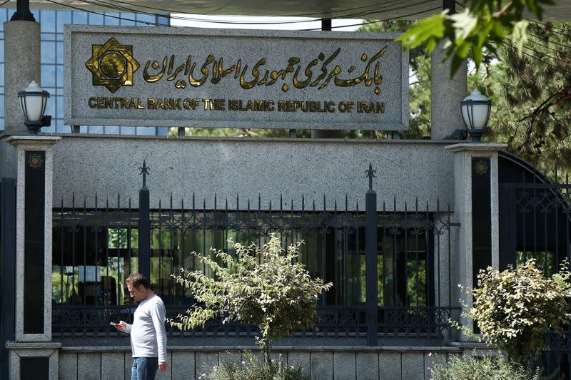 FILE PHOTO: A man walks past the Central bank of Iran in Tehran