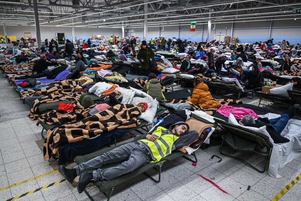 People who fled the war in Ukraine rest inside a temporary refugee shelter that was an abandoned TESCO supermarket after being transported from the Polish Ukrainian border on March 08, 2022 in Przemysl, Poland.
