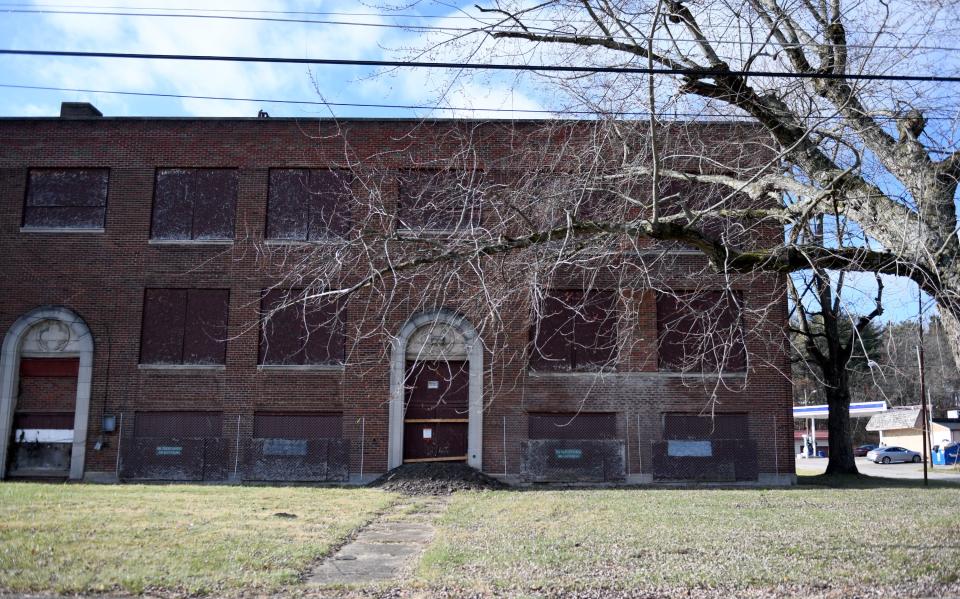 Because the former North Industry School attracts intruders, township officials have fastened chain-link fence guards over the windows, which have been covered with wooden sheets.